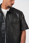 Black leather shirt worn by a person on a white background