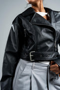Person wearing a black leather jacket with a gray background