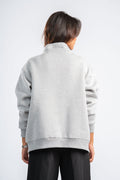 Person wearing a gray jacket on a white background