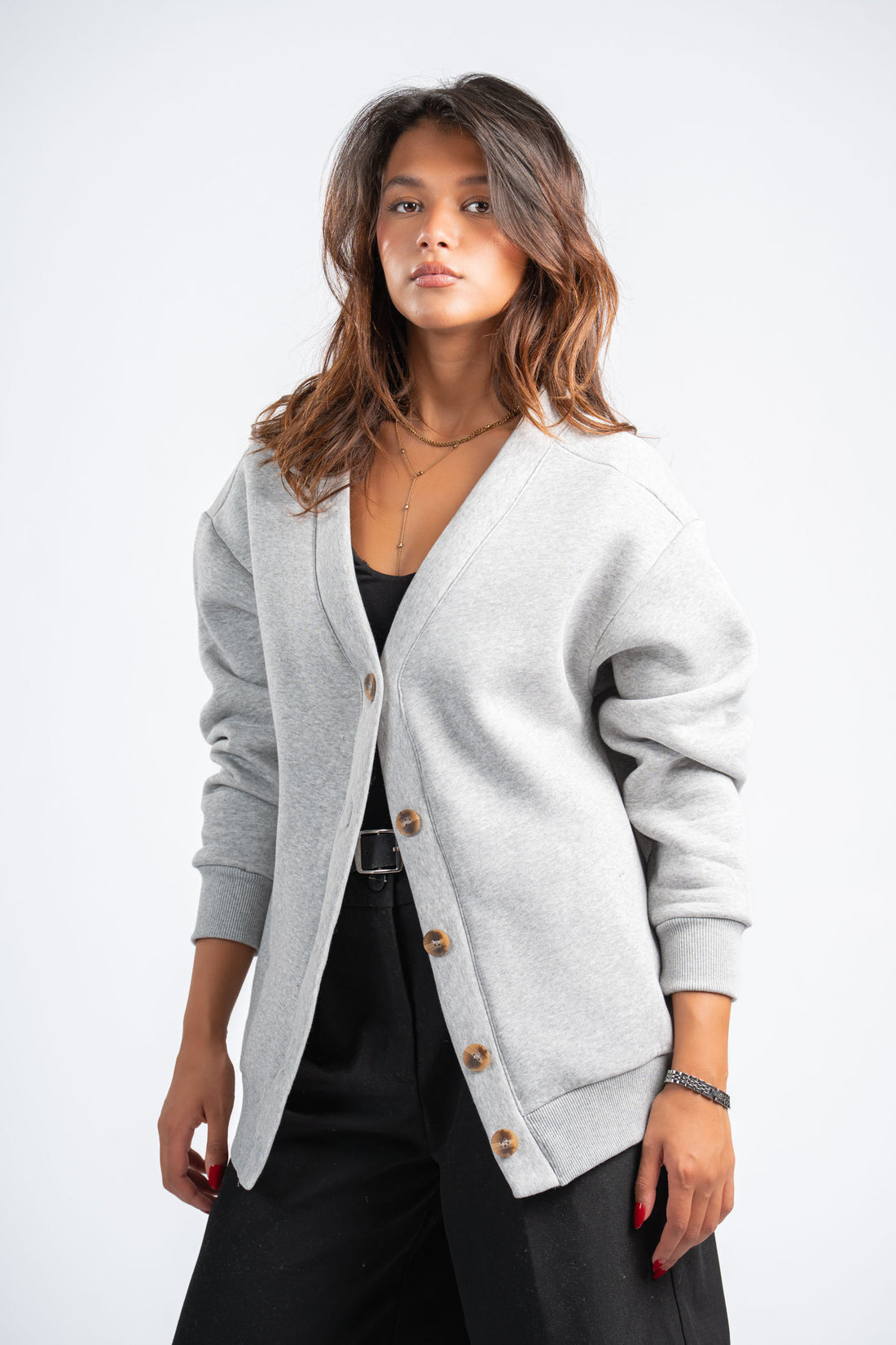 Woman wearing a gray cardigan on a white background