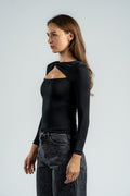 Woman wearing a black long-sleeve top with a unique design on a light gray background
