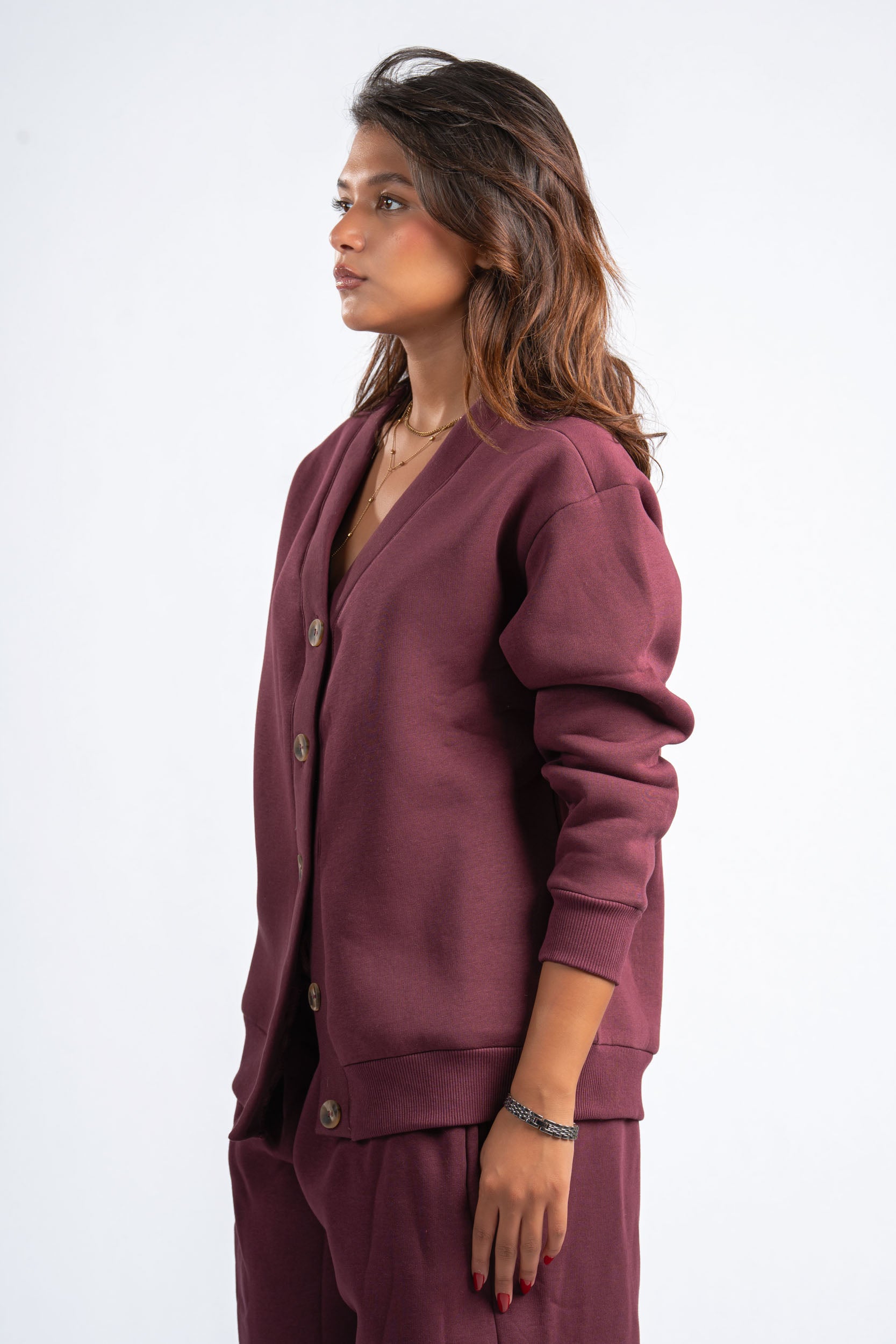 Woman wearing a maroon outfit on a white background