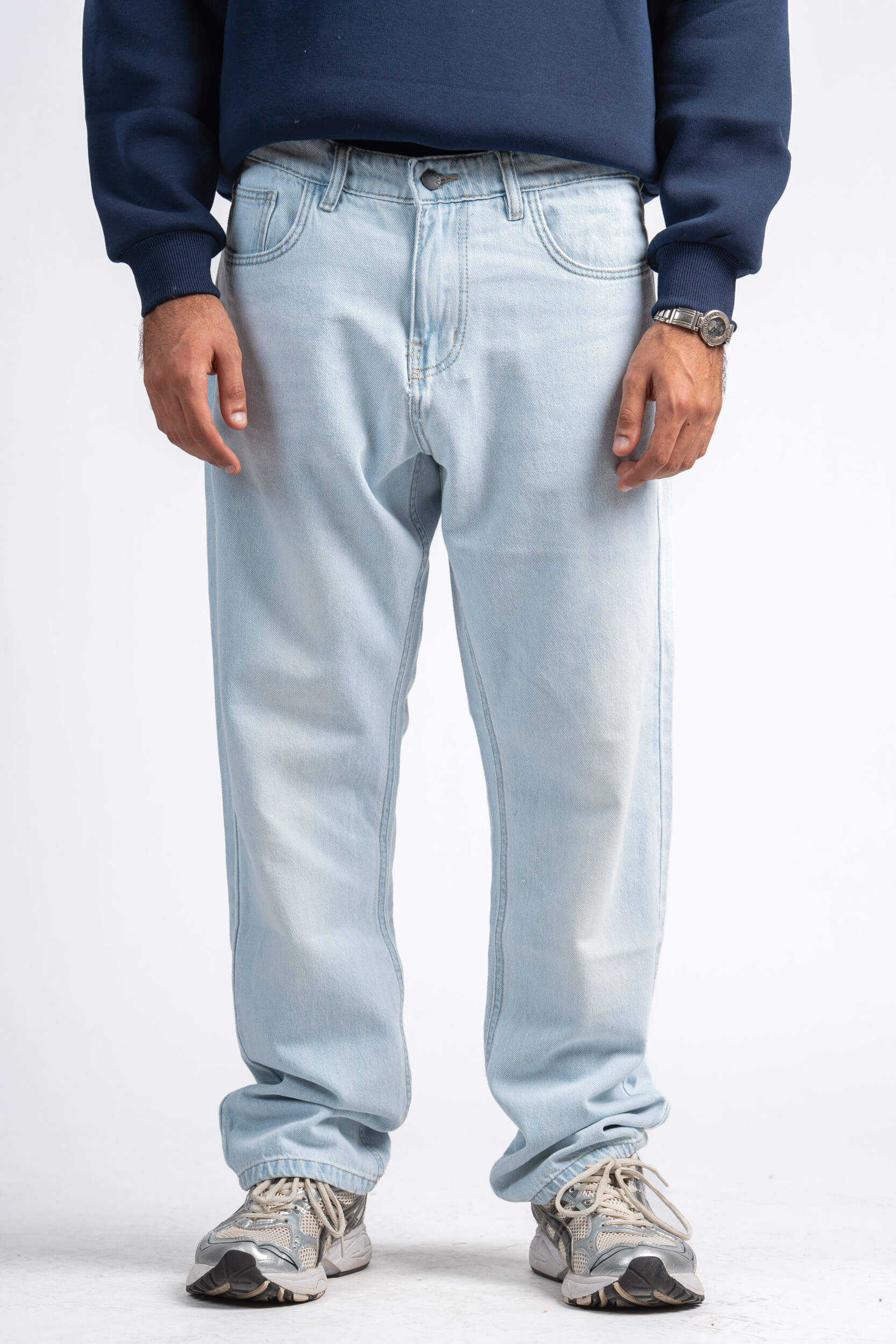 Light blue jeans worn by a person on a white background