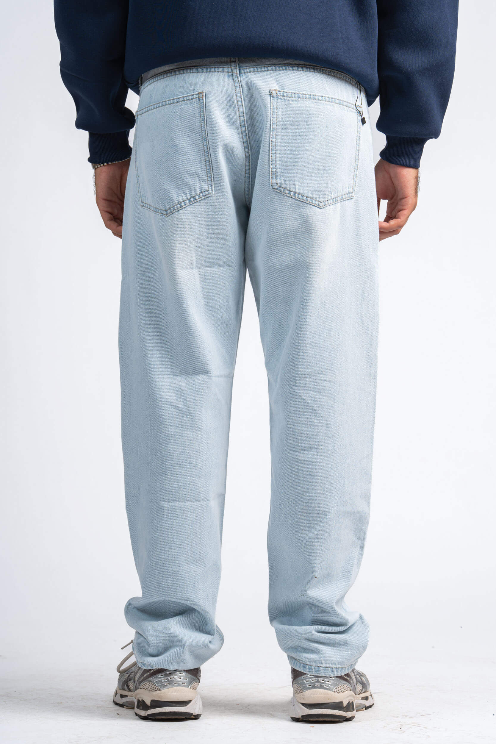 Light blue jeans worn by a person on a white background