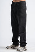 Black jeans worn by a person on a white background