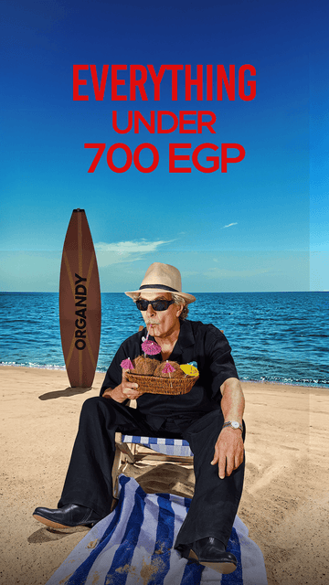A man in a straw hat and sunglasses sits on a beach chair on a sandy beach with the ocean and blue sky behind him. Large red text at the top reads 'EVERYTHING UNDER 700 EGP', and a surfboard-like object with the word 'ORGANDY' stands on the sand to the left.