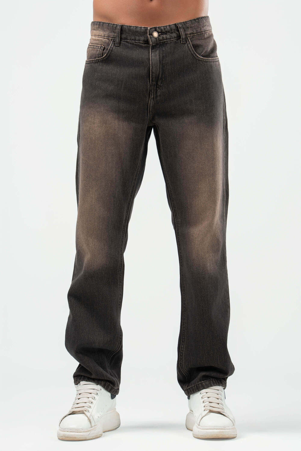 Dark jeans worn by a person on a white background