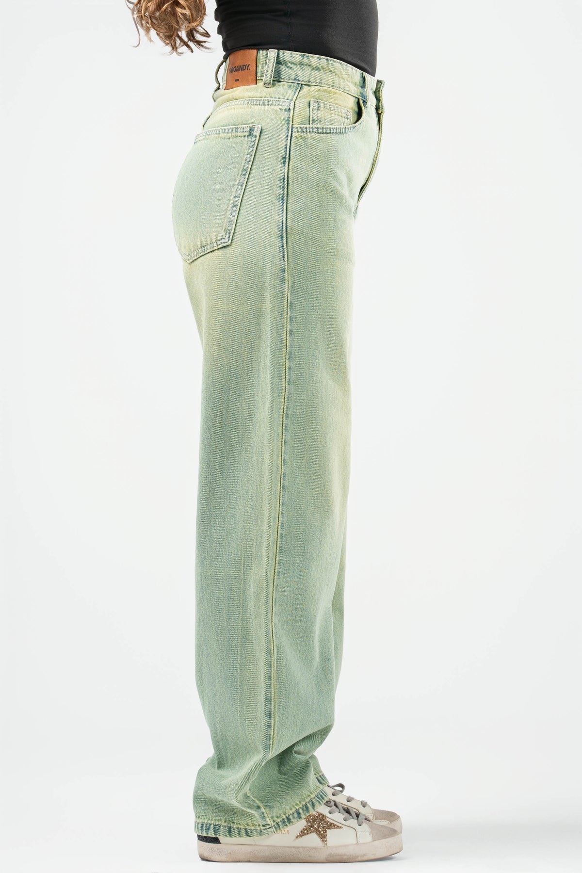 Light blue jeans worn by a person on a white background