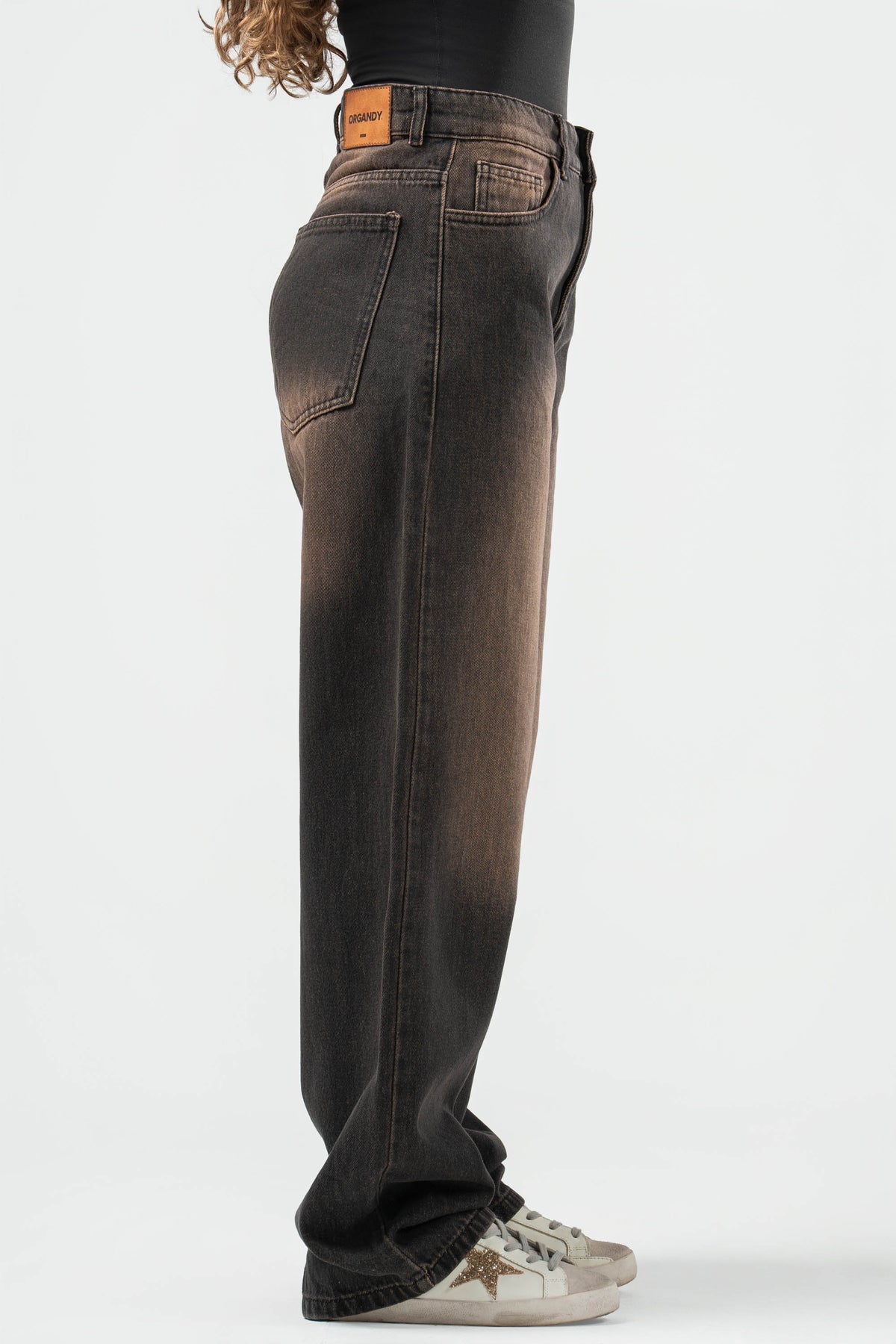 Brown wide-leg jeans on a white background