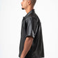Man wearing a black leather shirt on a white background