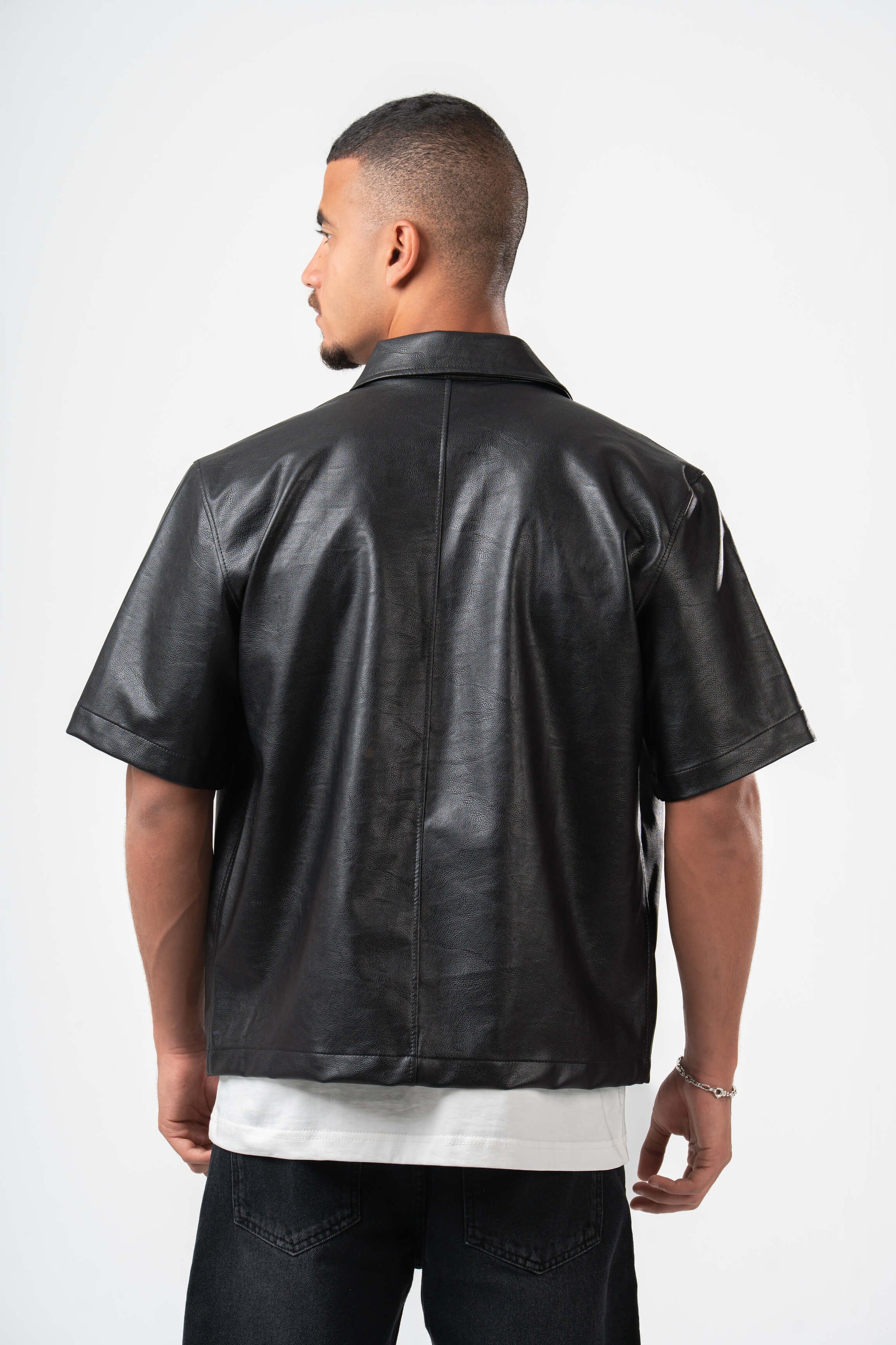 Man wearing a black leather jacket on a white background