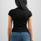Person wearing a black t-shirt and blue jeans against a plain background