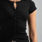 Person wearing a black ribbed shirt and blue jeans on a gray background