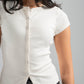 Woman wearing a white ribbed shirt with short sleeves against a gray background