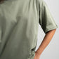 Person wearing a green t-shirt against a plain background