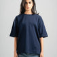 Person wearing a navy blue t-shirt and jeans on a gray background