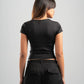 Person wearing a black t-shirt and black pants on a gray background