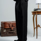 woman wearing a black pants against a neutral background