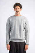 Man wearing a gray knitted sweater on a white background
