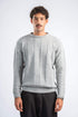 Man wearing a gray knitted sweater on a white background