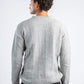 Person wearing a gray sweater on a white background