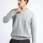 Man wearing a gray sweater against a white background