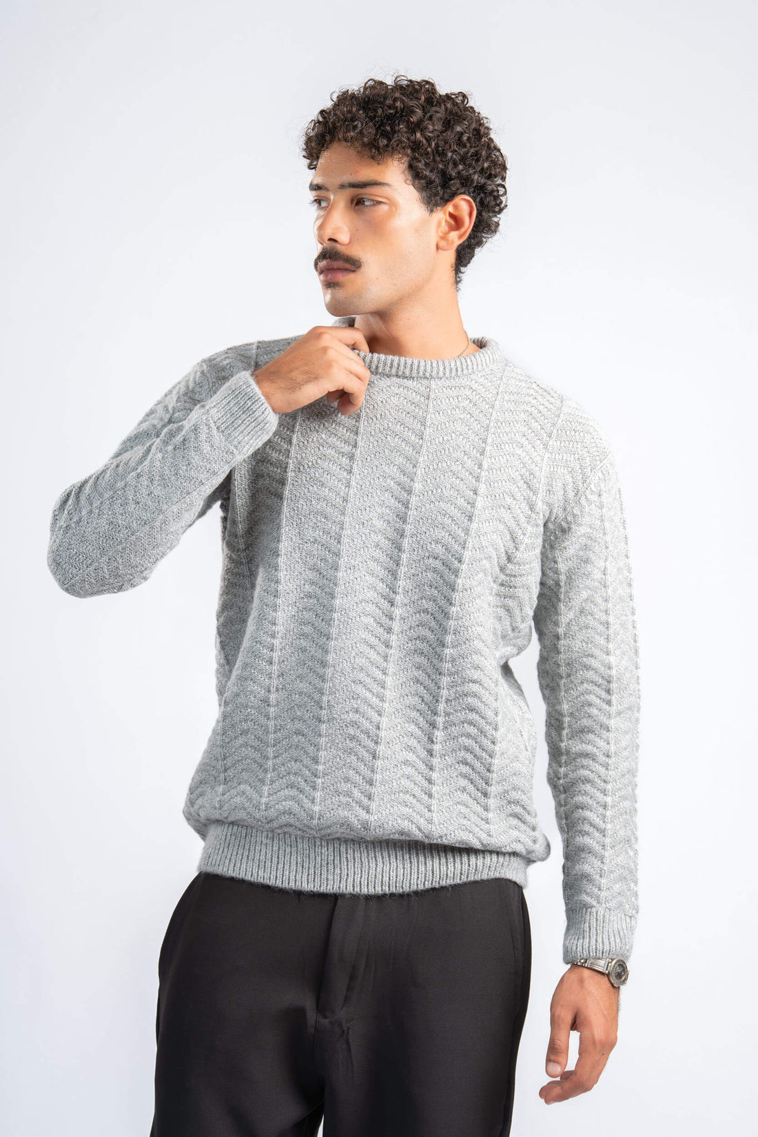 Man wearing a gray knitted sweater on a white background
