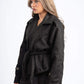 Woman wearing a black coat on a white background