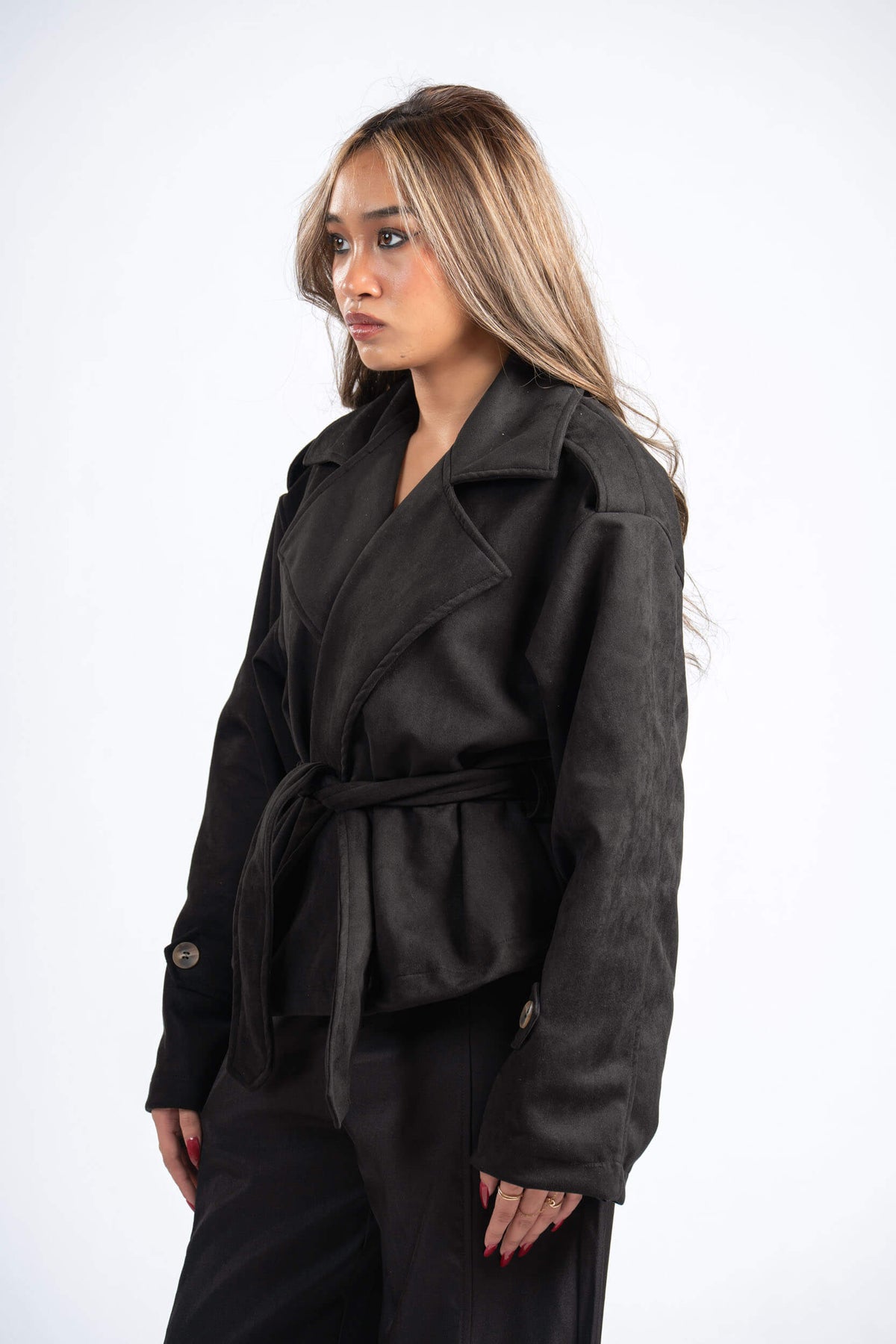 Woman wearing a black coat on a white background