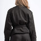 Person wearing a black jacket and pants on a white background