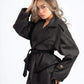 Woman wearing a black coat with a white background