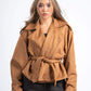 Woman wearing a brown jacket on a white background