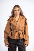 Woman wearing a brown jacket on a white background
