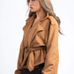 Woman wearing a brown jacket on a white background