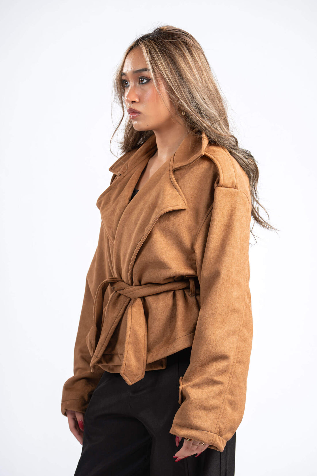 Woman wearing a brown jacket on a white background