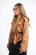 Woman wearing a brown jacket on a white background