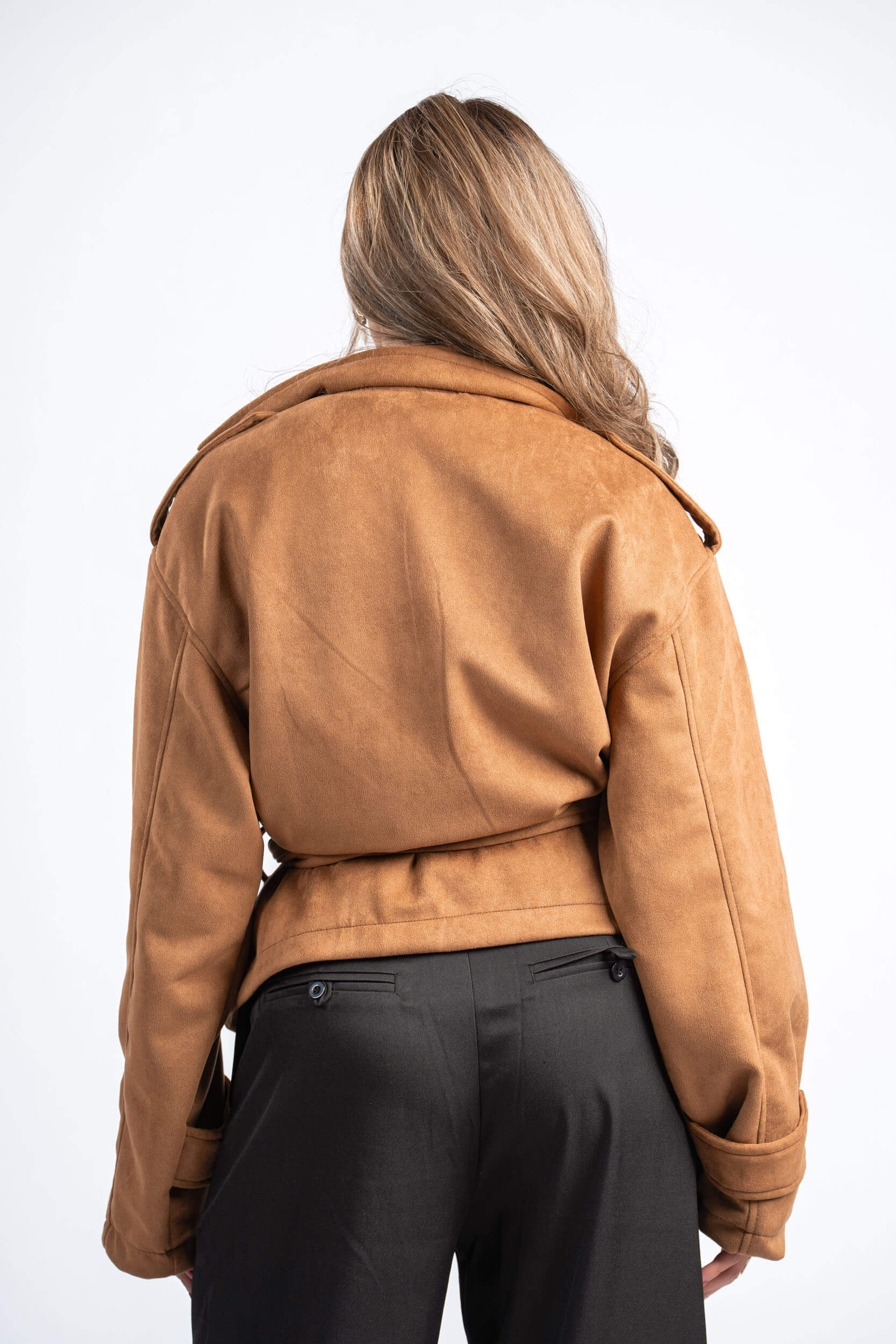 Person wearing a brown jacket on a white background