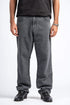 Person wearing gray jeans and black shoes on a white background