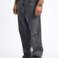 Person wearing gray jeans and black shoes on a white background