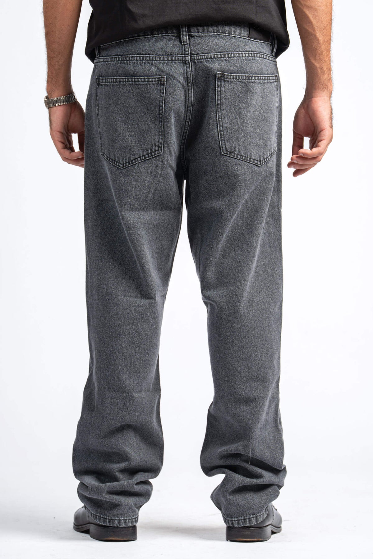 Person wearing gray jeans on a white background
