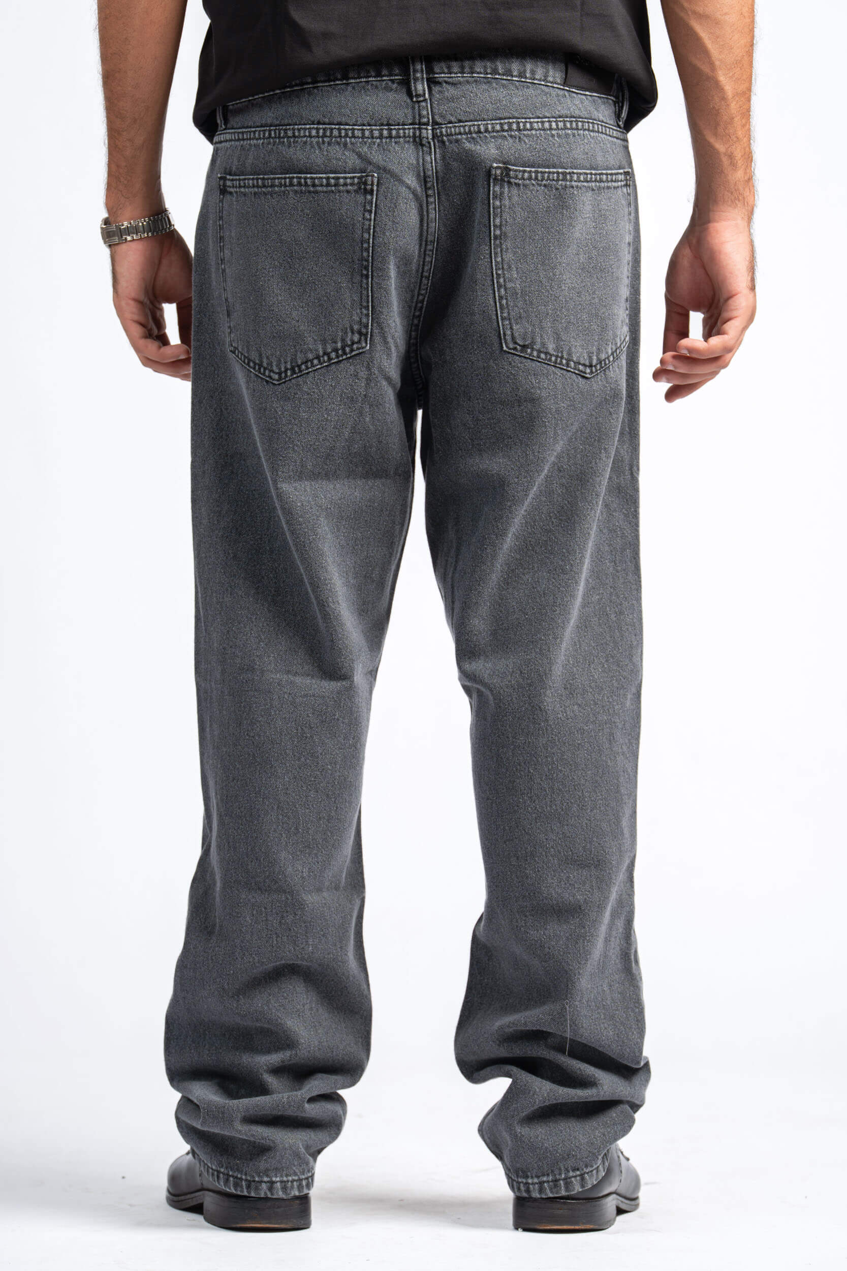 Person wearing gray jeans on a white background