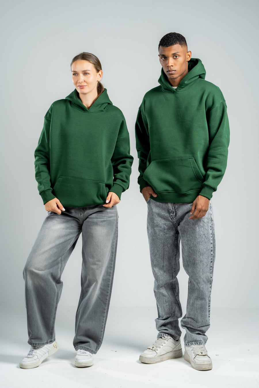 Two people wearing green hoodies and gray pants on a white backgroundshop_this_look_TThFR4