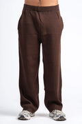 Brown pants worn by a person on a white background