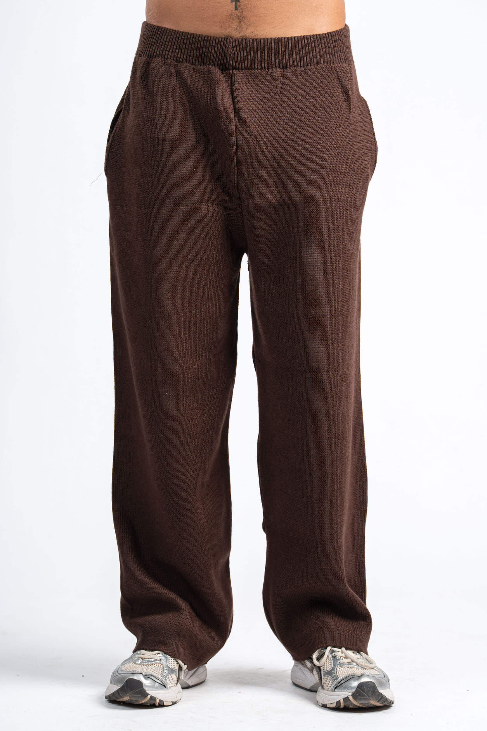 Brown pants worn by a person on a white background