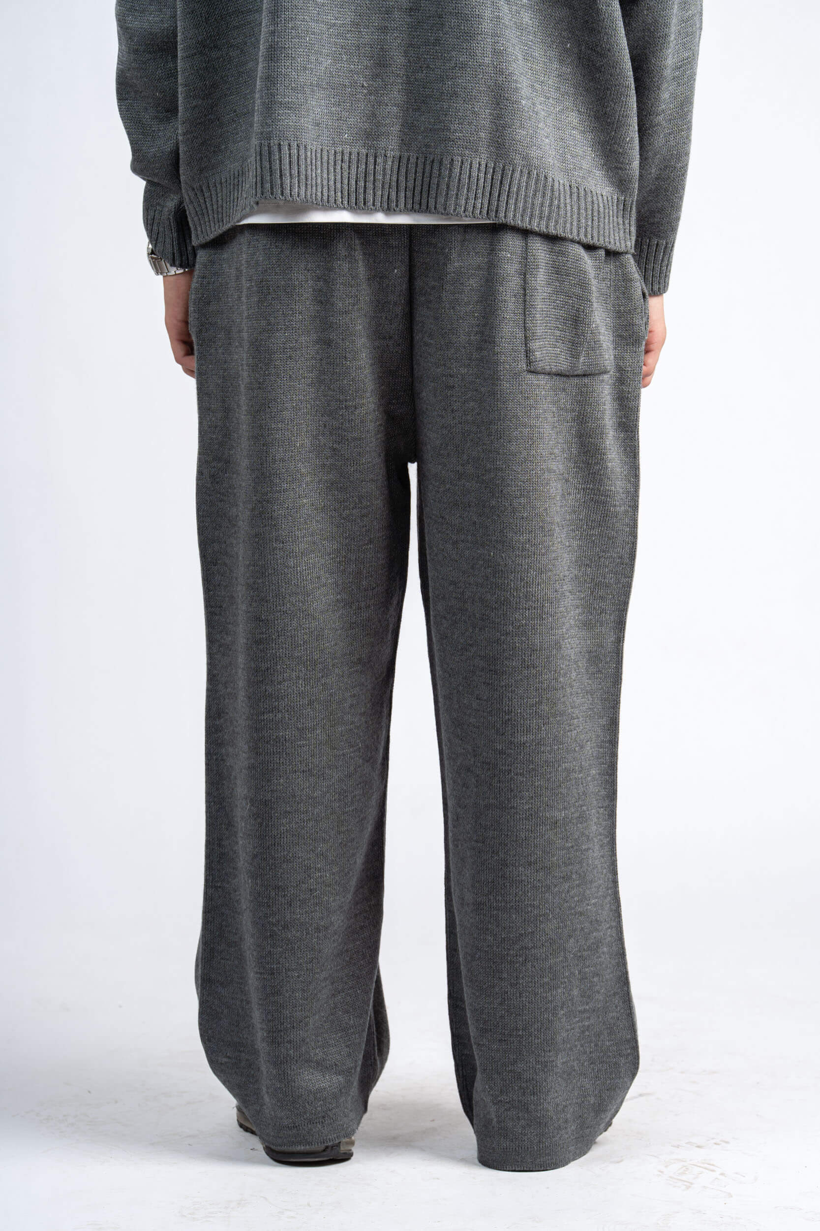 Gray knit sweater and pants on a white background