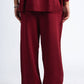 Maroon sweater and pants set on a white background