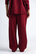Maroon sweater and pants set on a white background
