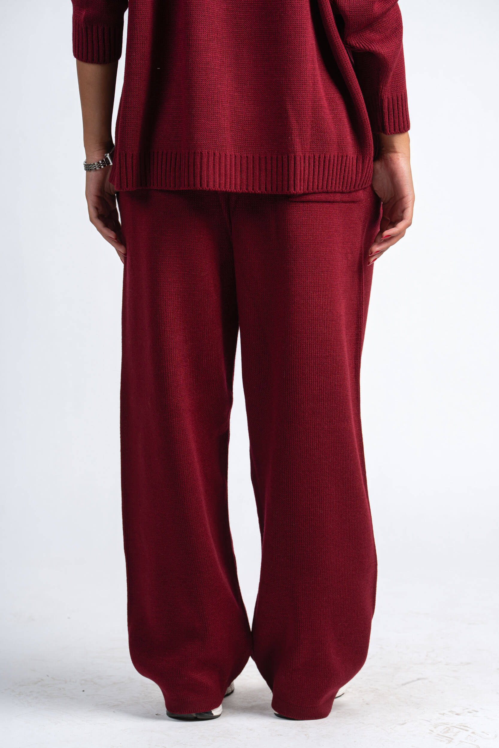 Maroon sweater and pants set on a white background