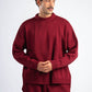 Man wearing a red sweater and pants on a white background