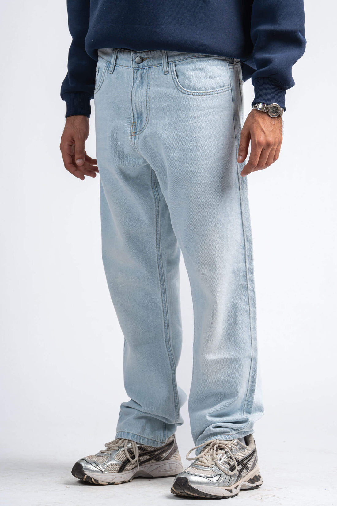 Light blue jeans worn by a person on a white background